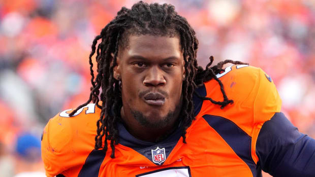 Broncos pass rusher Randy Gregory looks on without a helmet during a game.